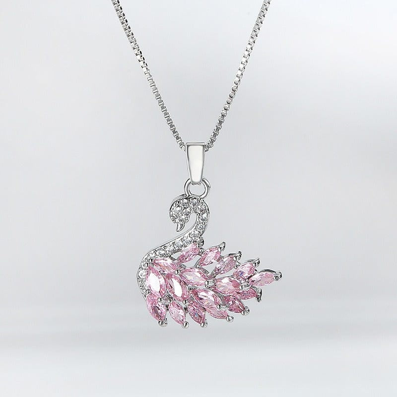 Pink gemstone pendant on a silver chain against a light gray background