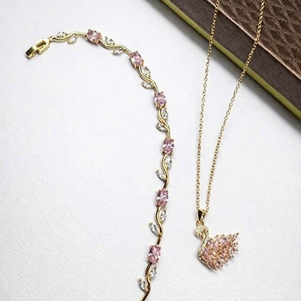 Gold necklace with pink gemstones on a white background
