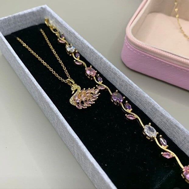 Jewelry box with a decorative necklace featuring a swan design and gemstones.