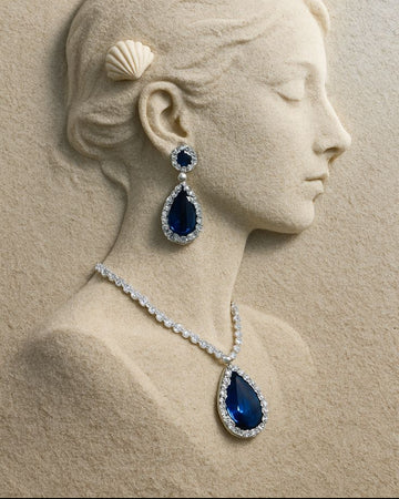 Blue gemstone necklace and earrings on a classical sculpture