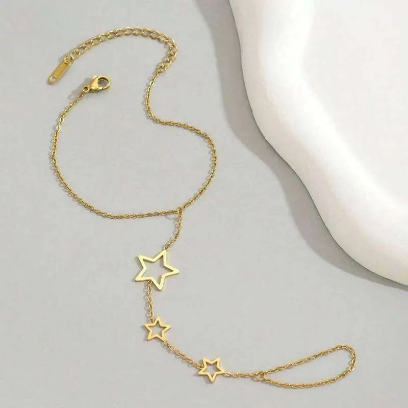 Gold star-shaped bracelet on a light gray surface