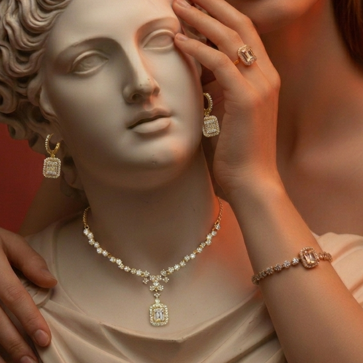 Person wearing diamond jewelry on a classical sculpture background