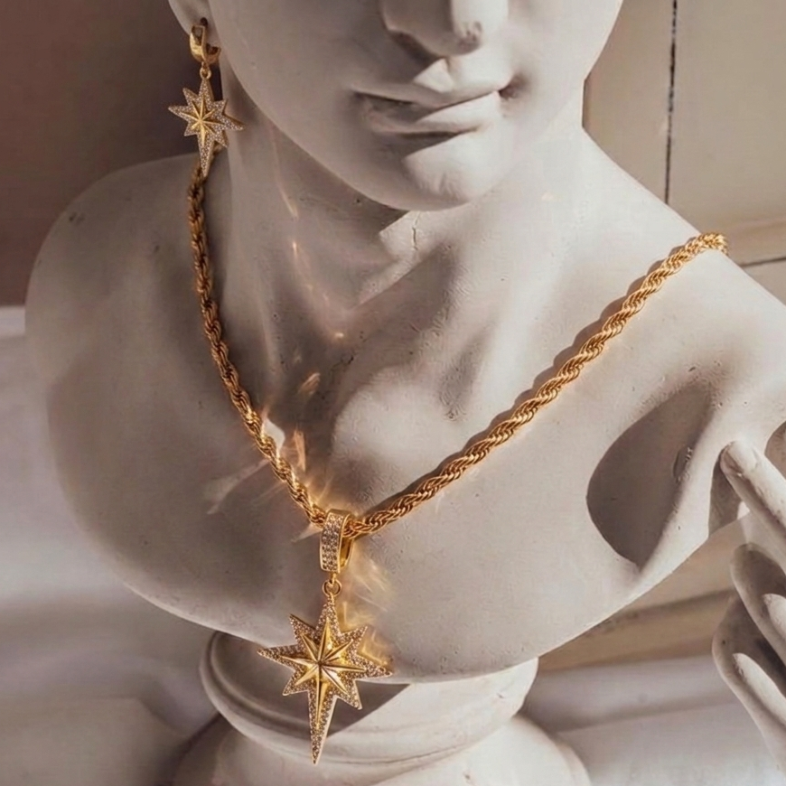 Gold necklace with star pendant on a marble bust