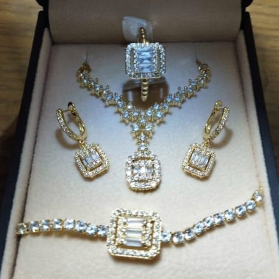 Gold jewelry set with necklace, earrings, and bracelet in a box.