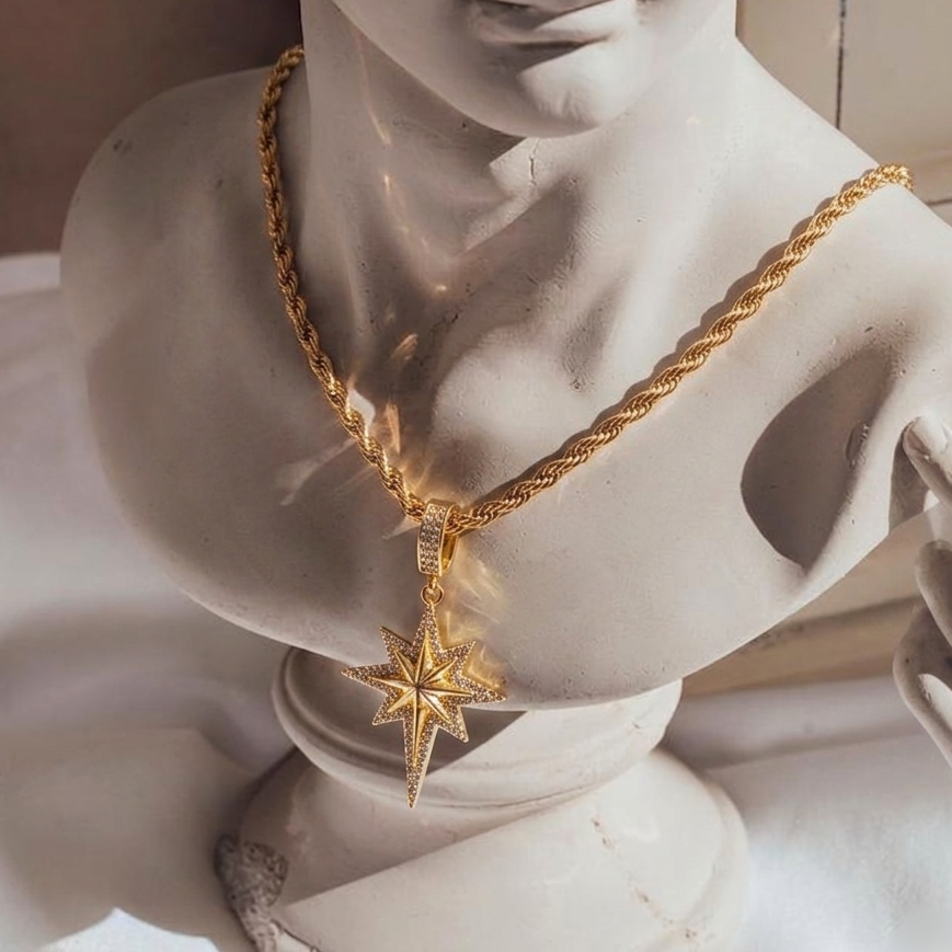 Gold necklace with a star pendant on a marble bust